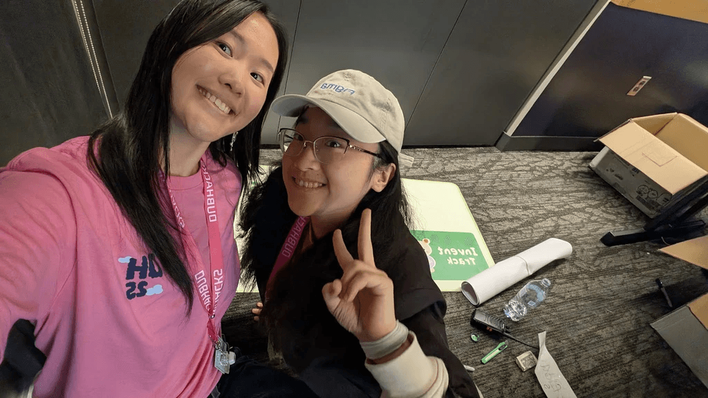 Photo of two DubHacks staff members smiling together after the event